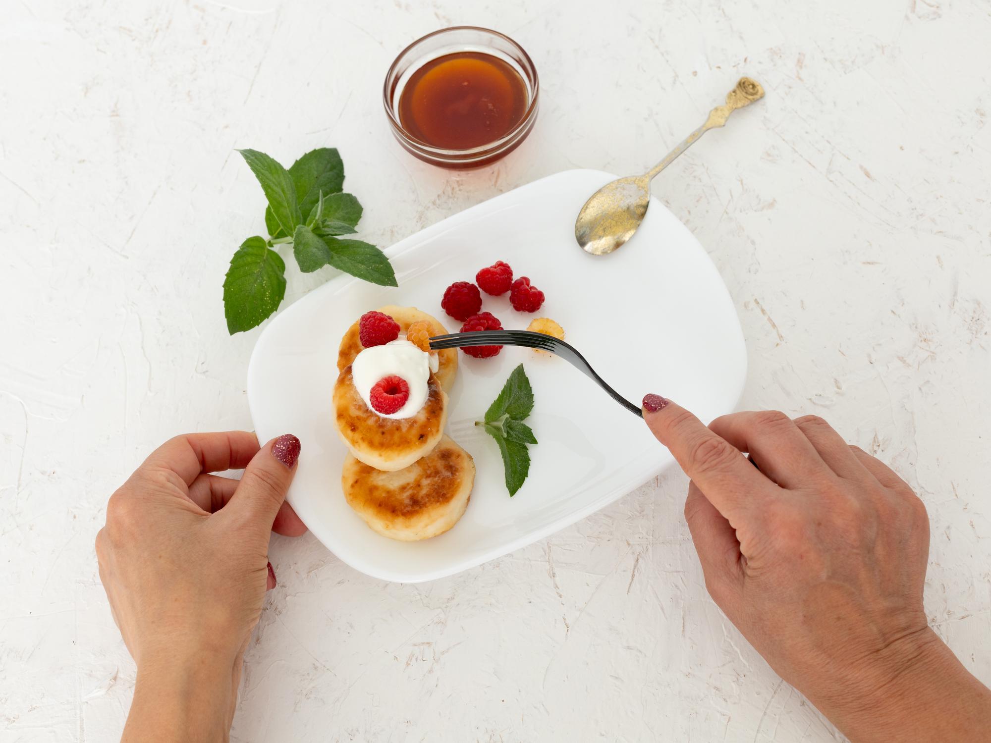 Hands finishing a dessert garnish